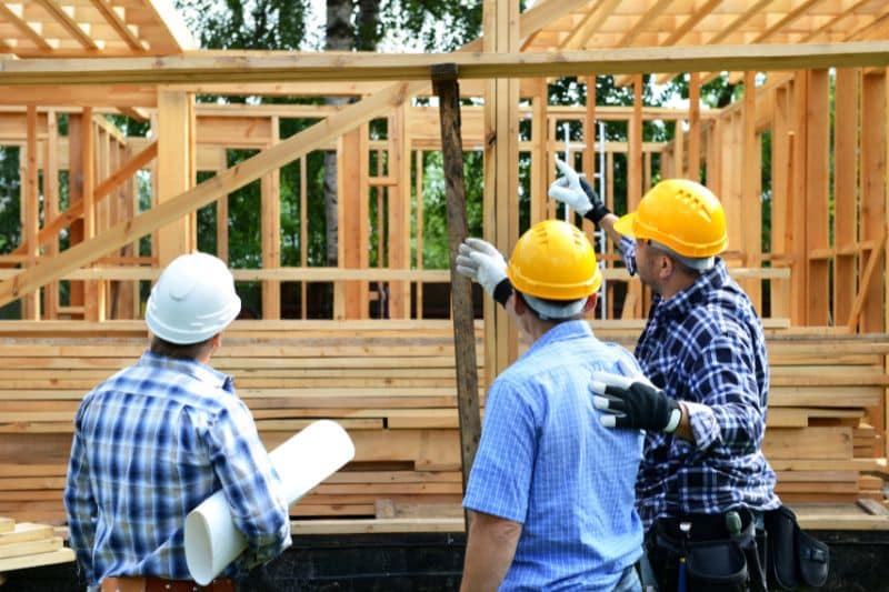 An image about construction worker reviewing the site and assessing the risks for construction risk management